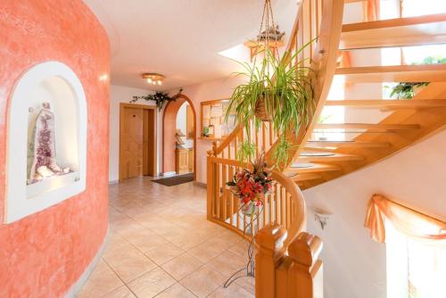 a staircase in a house with a plant at Pension- Appartement Kristall in Tröpolach