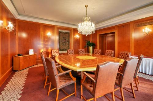 a dining room with a large wooden table and chairs at Hotel Devín in Bratislava