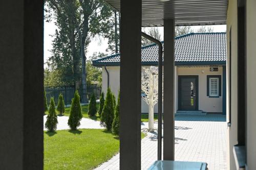 a view of a house with a yard with trees at Kintų Perlas Villa 4B in Kintai