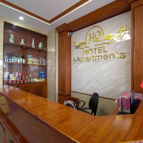 a bar in a hotel with a sign on the wall at HQ Hotel & Apartment in Hai Phong