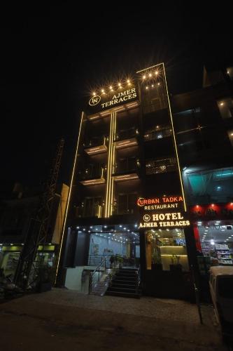 a building with a sign in front of it at night at AJMER TERRACES Hotel in Ajmer