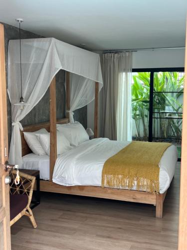 a bedroom with a bed with a canopy at ChiangMai清迈 cozy pool Villa 8rooms in Chiang Mai