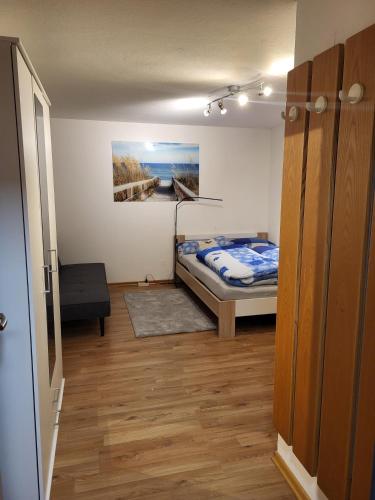 a bedroom with a bed and a painting on the wall at Haus Frei-Zambra in Vandans