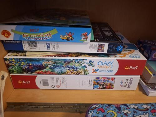 a stack of video game boxes on a shelf at 2 izbový byt 65 m2 so 4 lôžkami in Nitra