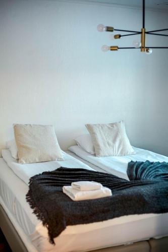 a bed with a black and white blanket on it at Nordic Bliss Apartment 1 in Inari