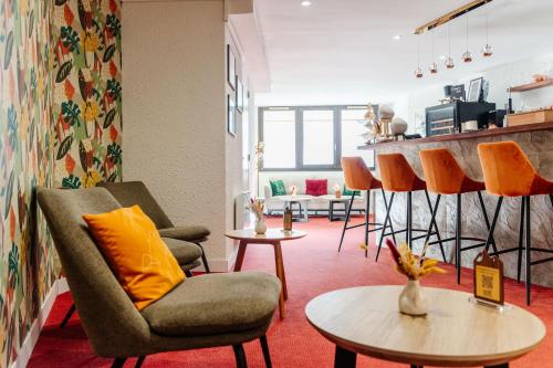 a living room with chairs and a table at Lake Hotel Courchevel 1850 in Courchevel