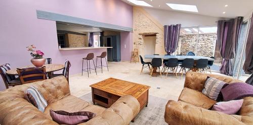 a living room with a couch and a table at Domaine de montboulon in Saint-Georges-sur-Baulche