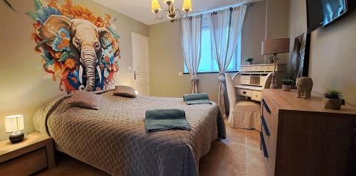 a bedroom with a bed with a painting of a zebra at Domaine de montboulon in Saint-Georges-sur-Baulche