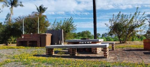 a bench and a picnic table in a park at Coconutpalm Home in Hengchun