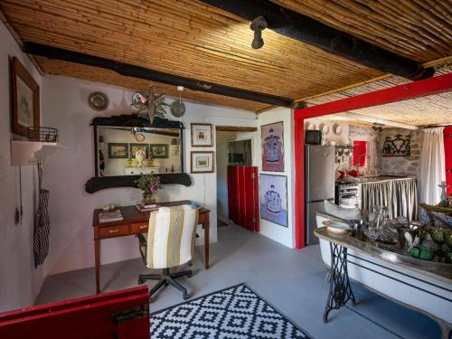 a kitchen with a desk and a refrigerator at Daniel's Kraal Guest Farm in Calitzdorp