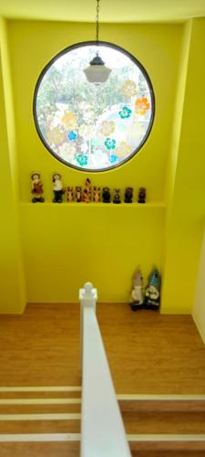 a room with a round window and some stairs at Coconutpalm Home in Hengchun