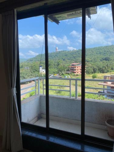 a room with a window with a view of a mountain at The Byke Skylark Seafront Resort, Dapoli in Murūd