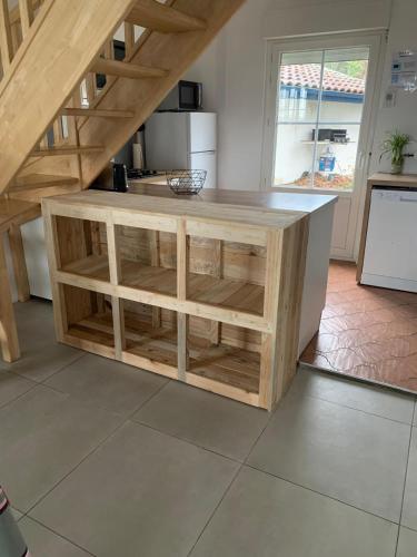 a kitchen with a wooden island in a room at L'Embrun Champêtre in Orthevielle