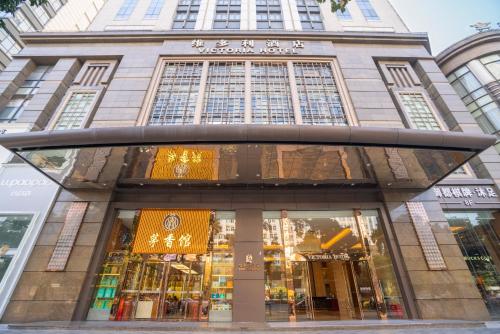 a store front of a tall building with windows at Victoria Hotel Guangzhou Zhujiang New Town - Free shuttle bus during Canton Fair period in Guangzhou