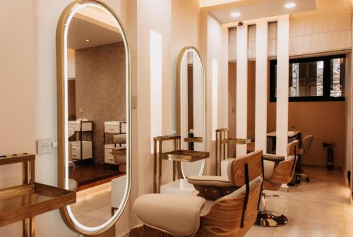 a dressing room with a mirror and some chairs at Golf du Rova Luxury Hotel in Antananarivo