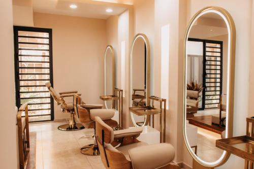 a salon with a row of mirrors and chairs at Golf du Rova Luxury Hotel in Antananarivo