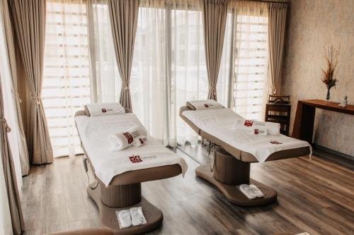 two hospital beds in a room with windows at Golf du Rova Luxury Hotel in Antananarivo