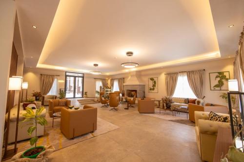 a large living room with couches and chairs at Golf du Rova Luxury Hotel in Antananarivo