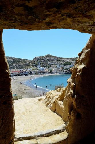 a view of a beach with people in the water at Eva Marina Hotel in Matala