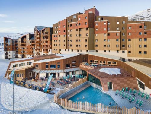 a resort with a swimming pool in the snow at Hôtel Club mmv Les Bergers **** in L'Alpe-d'Huez