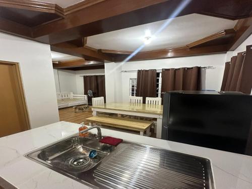 a kitchen with a sink and a counter top at Keps Boarding House in San Fernando