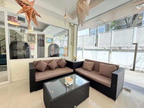 a living room with a couch and a table at Bangkok River Loka Hotel in Bangkok