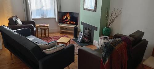 a living room with two couches and a fireplace at Fisherman's Terrace (Tardis) On Quay/Free Parking in Poole