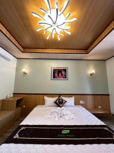 a bedroom with a bed with a large light above it at Kolia Resort in Cao Bằng
