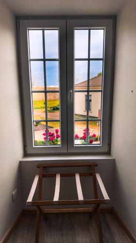 a window with a bench in a room with flowers at Sea Garden Peniche in Peniche