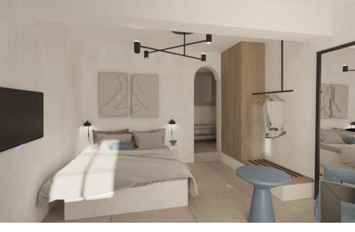 a bedroom with a bed and a blue stool at Andromeda Villas & Spa Resort in Imerovigli