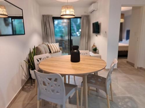 a wooden table and chairs in a living room at Allende Suite Villa Allende in Villa Allende
