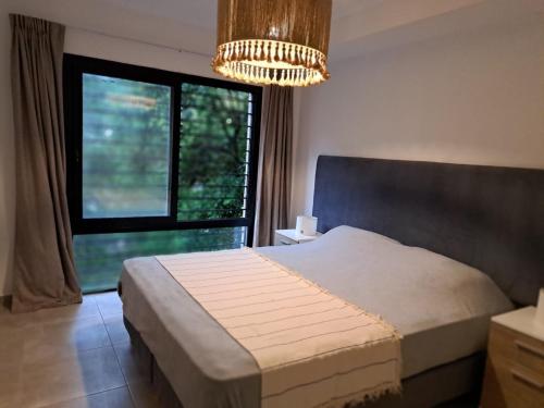 a bedroom with a bed and a large window at Allende Suite Villa Allende in Villa Allende