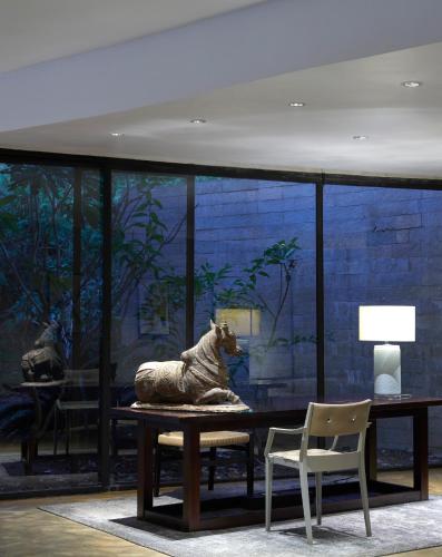 a room with a table with a statue of a horse at Dharana at Shillim All Inclusive Luxury Wellness Retreat in Lonavala