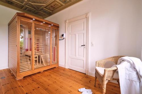 a room with a glass door and a wooden floor at Ferienwohnung Villa Wagersrott in Wagersrott