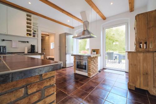 a large kitchen with a stone counter and a stove at Ferienwohnung Villa Wagersrott in Wagersrott