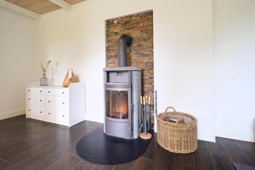 a fireplace in a living room with a brick wall at Ferienwohnung Villa Wagersrott in Wagersrott