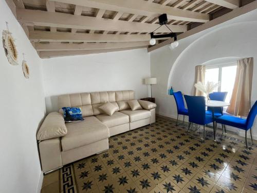 a living room with a couch and a table and chairs at El Encanto de Jerez in Jerez de la Frontera