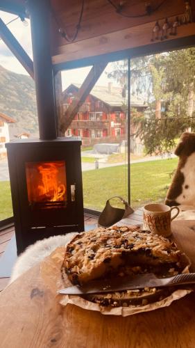 a pastry on a table in front of a fireplace at Chalet Myriam in Grächen