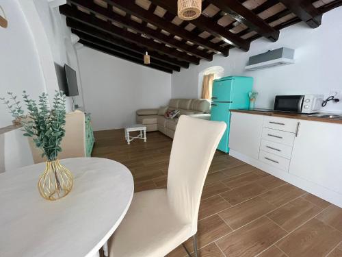 a kitchen and living room with a table and chairs at El Encanto de Jerez in Jerez de la Frontera