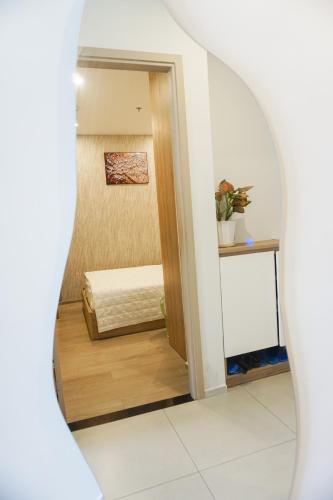 a mirror reflection of a room with a bed at Erica's House - Oceanview The Sóng Apartment Vũng Tàu Nghỉ Dưỡng Biển Cao Cấp 5 Sao - The Song Vung Tau Condotel 5 Star Beach View Apartment in Vung Tau