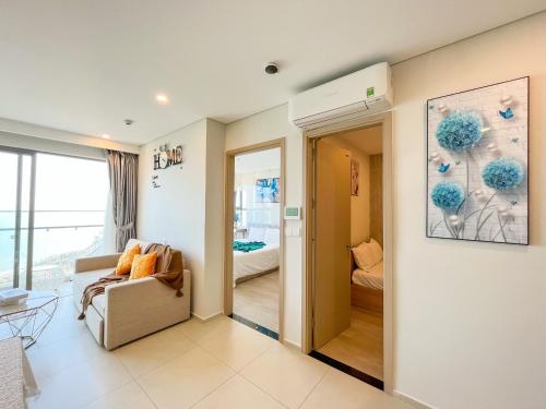 a living room with a couch and a bedroom at Erica's House - Oceanview The Sóng Apartment Vũng Tàu Nghỉ Dưỡng Biển Cao Cấp 5 Sao - The Song Vung Tau Condotel 5 Star Beach View Apartment in Vung Tau