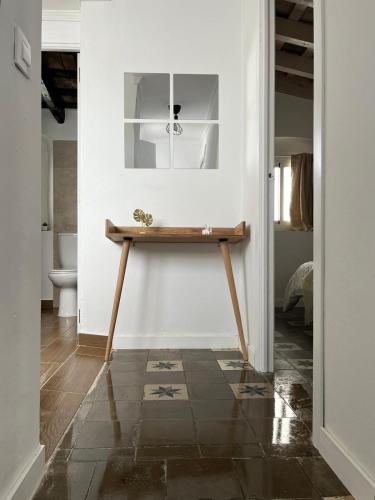a hallway with a wooden table in a room at El Encanto de Jerez in Jerez de la Frontera