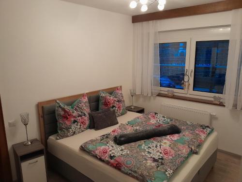 a bedroom with a bed with pillows and a window at Ferienwohnung Christina in Möllbrücke