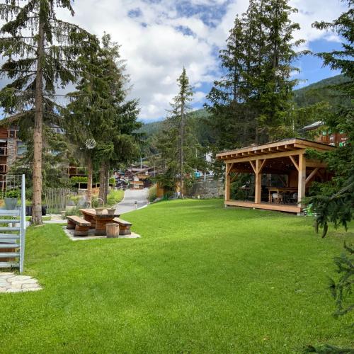a park with a pavilion and green grass at Chalet Myriam in Grächen