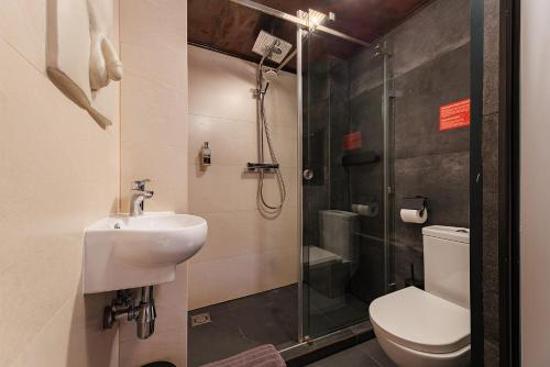 a bathroom with a shower and a toilet and a sink at Masoch. Hotel & Cafe in Lviv