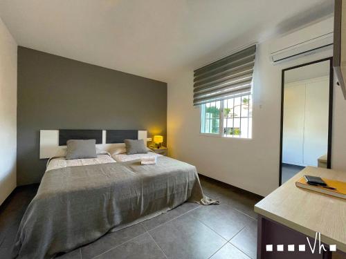 a bedroom with a large bed and a window at VH CostaBlanca - MORAVIT in Moraira
