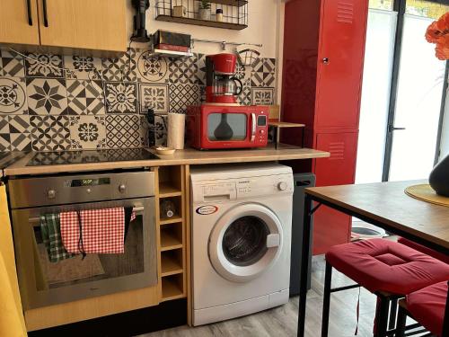 une cuisine avec un lave-linge et un micro-ondes dans l'établissement SP570-A101 Appartement 2 pièces - balcon - parking - Saint Pierre la mer, à Saint Pierre La Mer