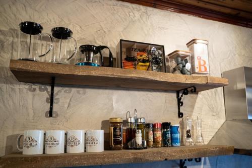 a shelf with several coffee mugs on it at Dandy Villas Metsovo - Avo - Fireplace - Up to 6 in Metsovo