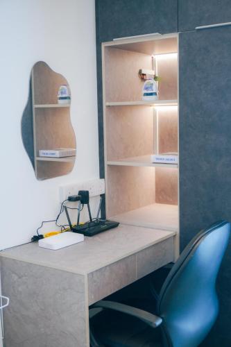 a desk with a blue chair in a room at i-Sovo i-City-3sleep-Netflix-Gym in Shah Alam