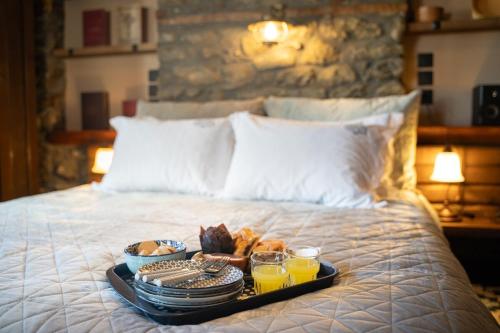 a tray with food and drinks on a bed at Dandy Villas Metsovo - Avo - Fireplace - Up to 6 in Metsovo